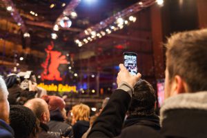 BERLIN, GERMANY - FEBRUARY 08: People watching the red carpet walk during 65th Berlinale International Film Festival at Berlinale Palace on February 8, 2015 in Berlin, Germany.